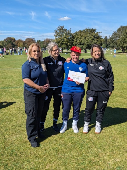 Ellen Maggs being presented with a Lioness Award and England cap from London FA for services to women's football