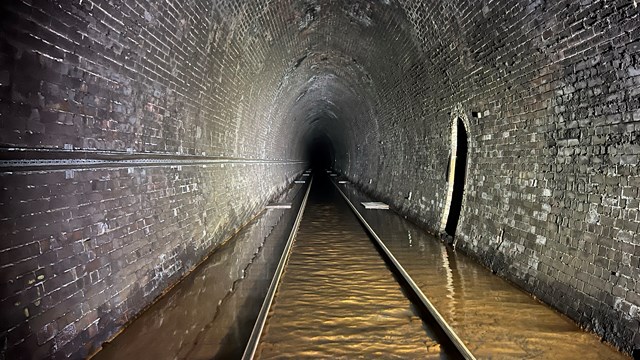Whitehaven railway tunnel testing to seek source of mystery orange water: Flood water in Whitehaven tunnel containing iron ochre