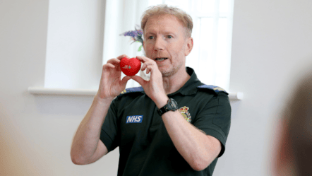 Paul Brolly stood holding a small red toy heart in front of him.