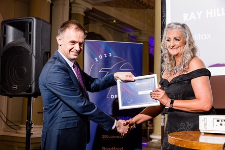 Sally Lyle receives her award from Tom Bridge, Operations Director of First West Yorkshire