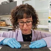 Clara Molina Sanchez, Applied Conservation Manager at HES, examines a piece of Islamic glass at the Engine Shed in Stirling.: (c) Historic Environment Scotland