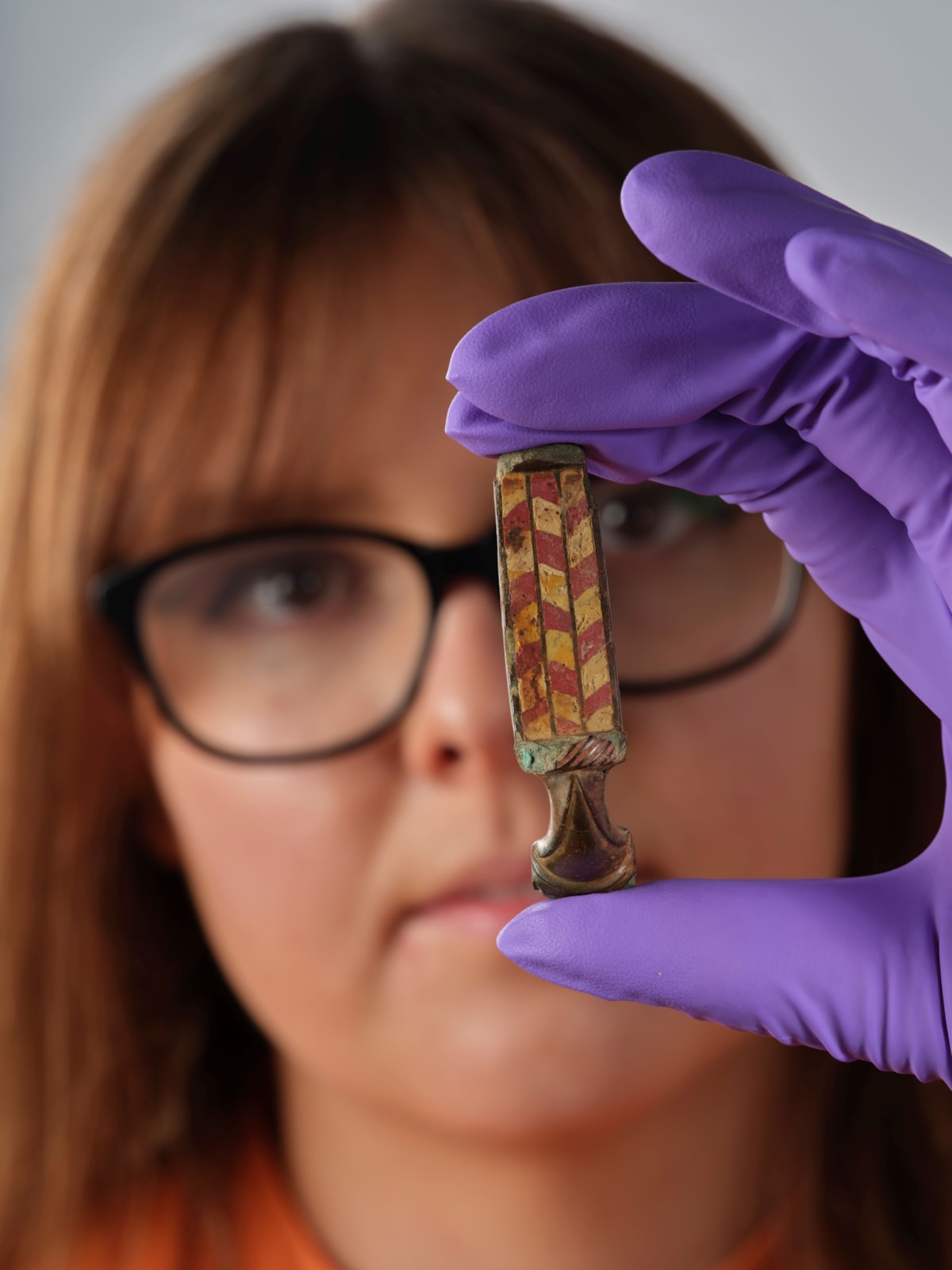 Assistant Curator Bethany Simpson with the Pathhead brooch. Image © National Museums Scotland 2