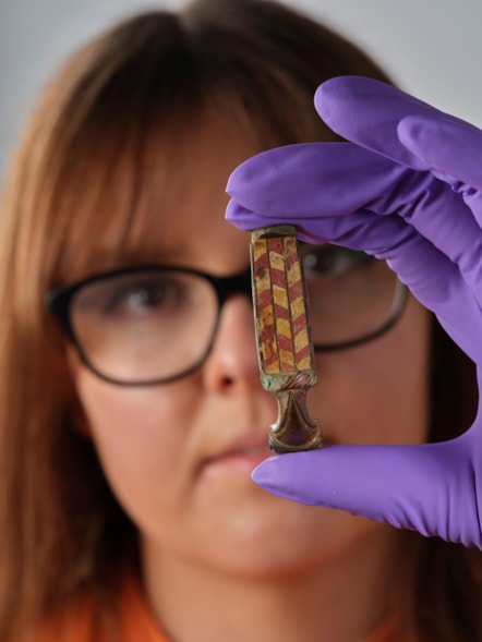 Assistant Curator Bethany Simpson with the Pathhead brooch. Image © National Museums Scotland 2