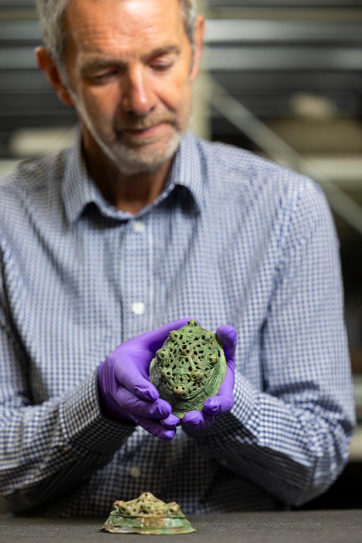 Assistant Curator Craig Angus with Viking brooches. Photo © Duncan McGlynn (3)