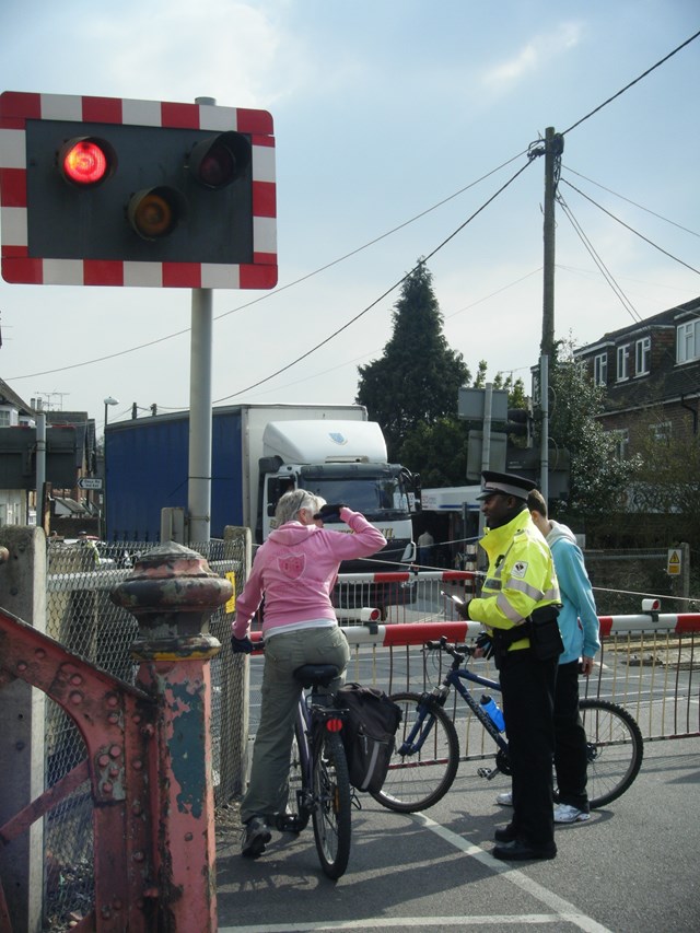 Billingshurst Level Crossing Awareness Day: A police officer discusses using level crossings safely with cyclists at Billingshurst