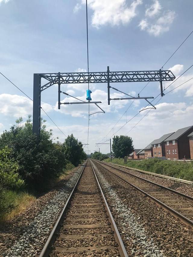 Portrait shot of the balloon on the overhead lines at Prescot