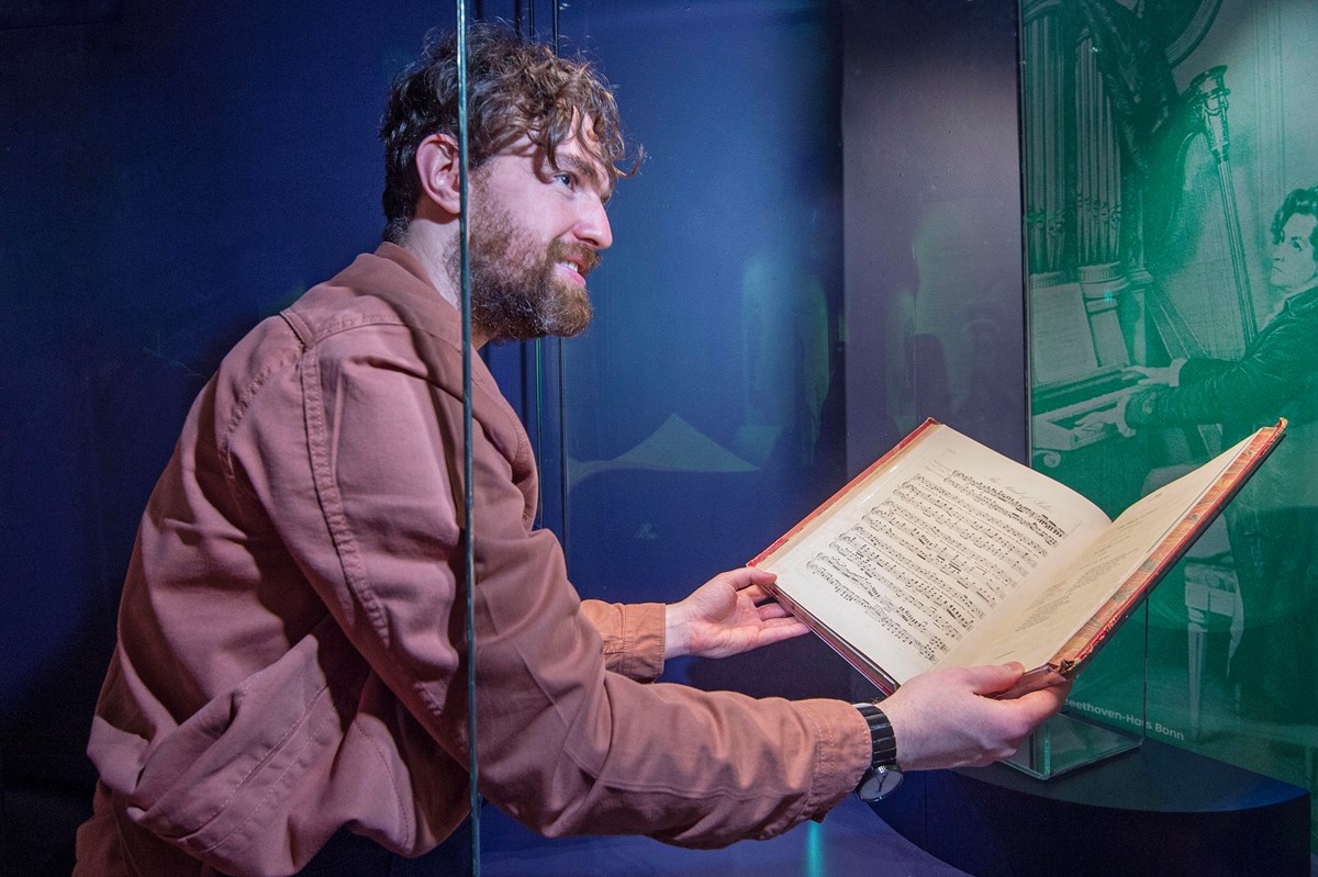 Conservation Exhibitions Specialist Ryan Gibson installing material related to Ludwig van Beethoven. Credit: Neil Hanna