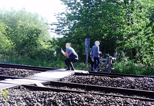 A woman takes a selfie on the tracks at Flint Marsh