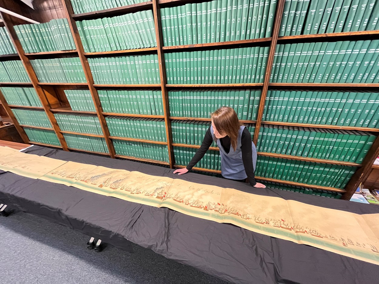 Leeds Central Library's naval battle: Leeds Central Library's senior librarian Rhian Isaac with sections of the step-by-step, illustrated account of the battles of Solebay and Texel which took place in the 1670s. Estimated to be more than 50 feet in length, the document itself dates from around 1908 and is among a collection of more than 3,000 books, pamphlets and periodicals donated by noted Leeds aristocrat, diplomat and naval history buff Sir Alvary Gascoigne.