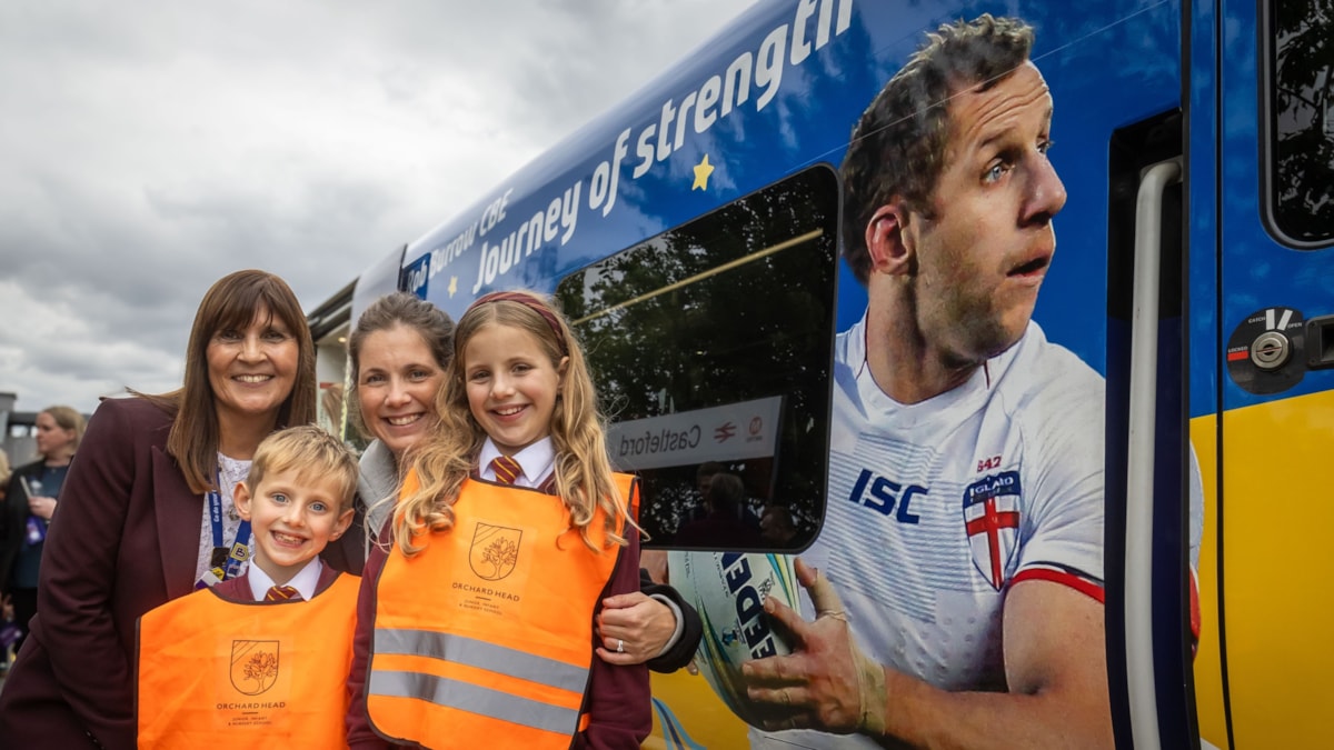 Lindsey Burrow, two of her children Maya and Jackson, and Northern's managing director Tricia Williams with the Rob Burrow train