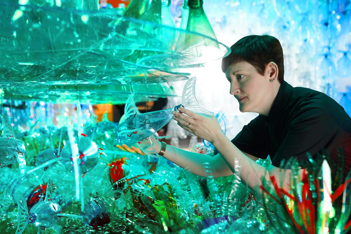 Curator Dr Ali Clark with the Bottled Ocean 2123 installation by George Nuku, part of a new exhibition, Rising Tide: Art and Environment in Oceania which opens Saturday 12 August at the National Museum of Scotland (credit Stewart Attwood)