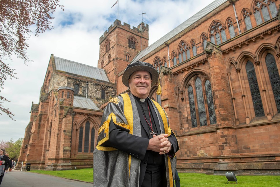 Archbishop of York Stephen Cottrell in academic robes outside Carlisle Cathedral at his inauguration as Chancellor of University of Cumbria