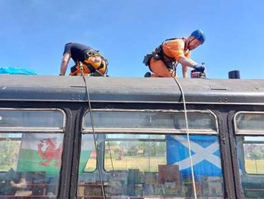 This image shows the team repairing the leak to the roof