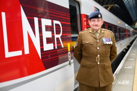 LNER driver and Army Reserve Sgt Jamie Bond stood next to an LNER Azuma