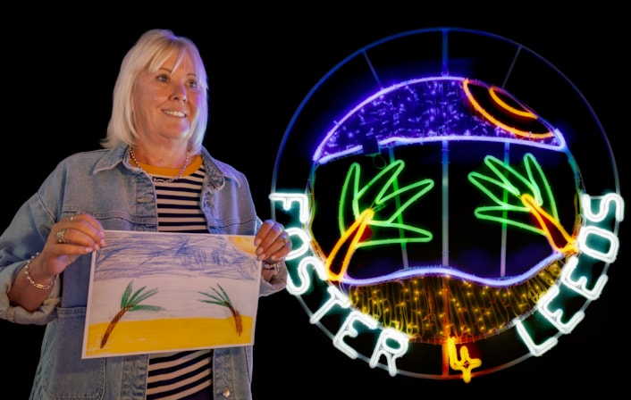Foster 4 Leeds Light Night 1: Foster carer Marie Procter, pictured with the drawing created by the 14-year-old boy in her care and the resulting neon rope light for Light Night Leeds.