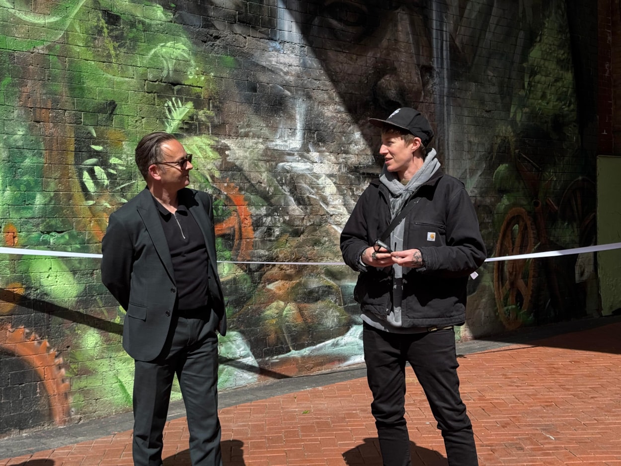 Mural Penny Pocket Park-6: Simon Hodgson, Leeds City Council's head of community safety and Jay Gilleard, or Cbloxx who designed and painted the mural.