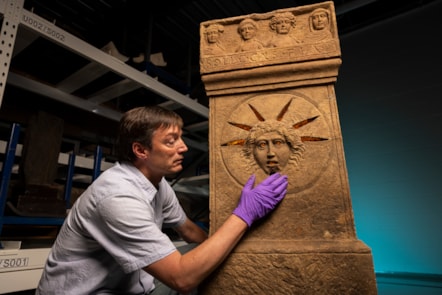 Curator Dr Fraser Hunter examines the Roman altars.Photo © Duncan McGlynn (5)