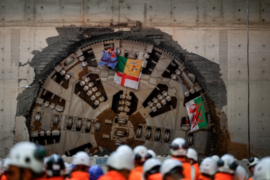 Giant cutterhead of HS2 Tunnel Boring Machine Mary Ann that completed the first tunnel breakthrough in Birmingham: With Aston Villa flag, Donegal flag, St George's flag, and St David's flag