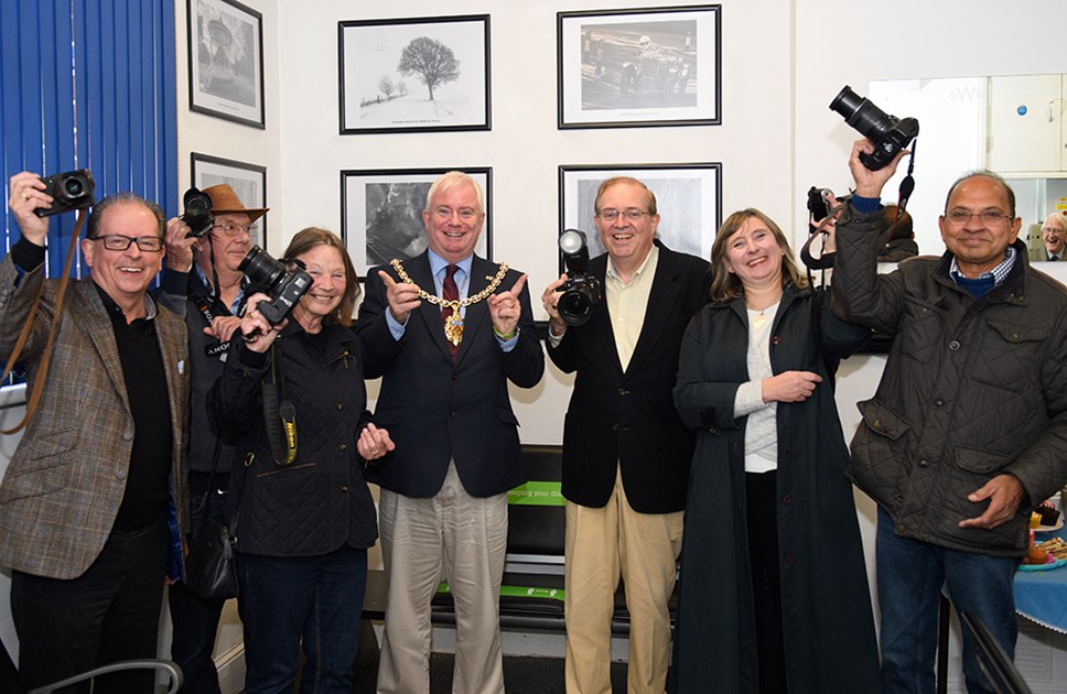 Cheltenham Borough Council Mayor, Councillor Steve Harvey, with members of Cheltenham Camera Club at the launch of their exhibition at Cheltenham Spa station.