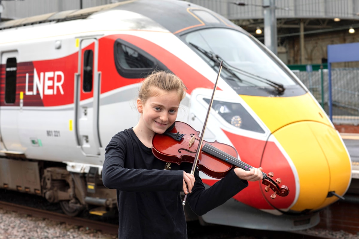 Linlithgow String Orchestra young member besides an LNER Azuma.