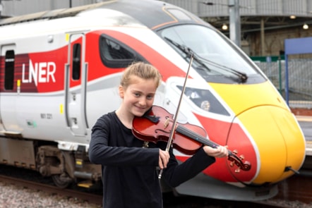Linlithgow String Orchestra young member besides an LNER Azuma.