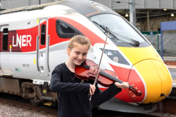 Linlithgow String Orchestra young member besides an LNER Azuma.