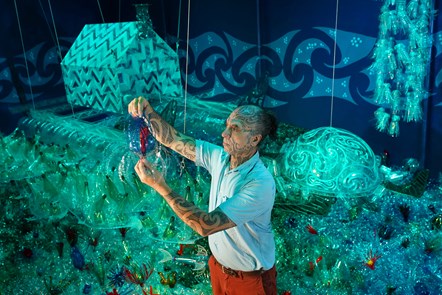 Artist George Nuku puts the finishing touches to the installation of the artwork Bottled Ocean 2123