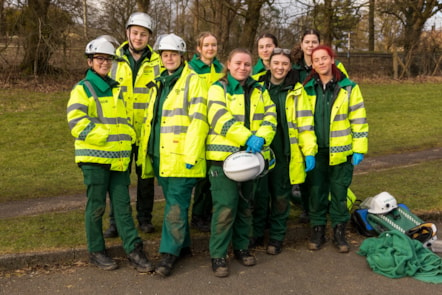 A group of paramedic students from University of Cumbria wearing their distinctive green and high-vis uniforms