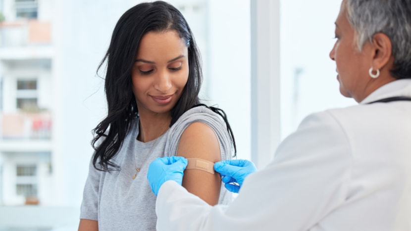 Health chiefs urge those eligible for a free flu vaccine to book their jab as flu cases continue to rise: healthcare-worker-applying-bandage
