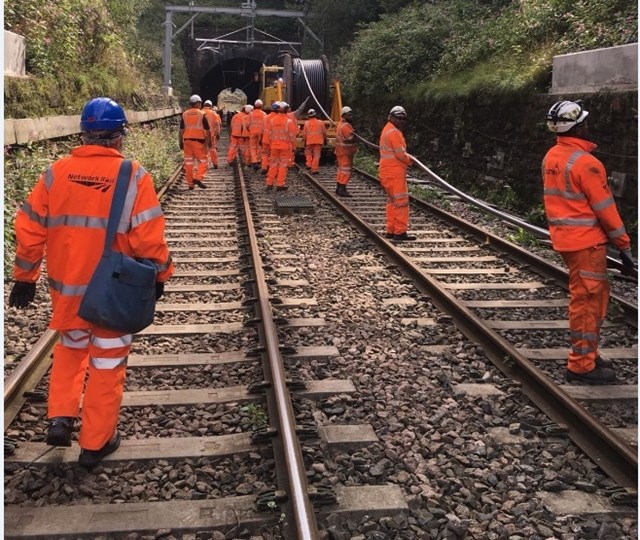 Team Orange installing power cables to supply new overhead equipment with electricity