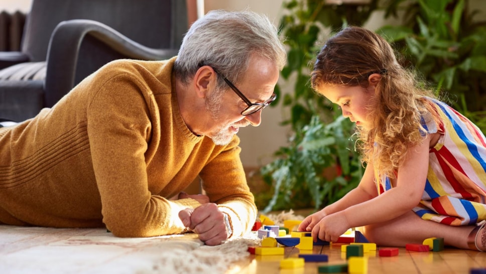 Grandfather and granddaughter playing