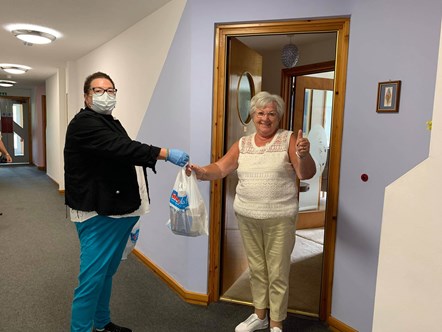 74 year-old Janet receives lunch from Christine from Buckie Central East Locality Group