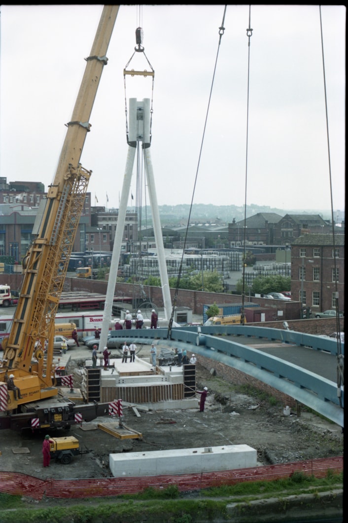Centenary Bridge: Originally constructed in 1993, at that time the bridge was the first river crossing built in the city for more than a century, and its distinctive sweeping design has since become a much-loved riverside feature. Picture shows the bridge being winched into place during construction. Credit Yorkshire Design Group.
