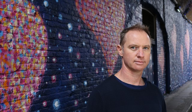 Jimmy C poses with his artwork in Southwark