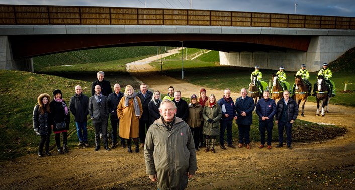 Martin Clunes, Councillor Helen Hayden, staff of Leeds City Council and members of The British Horse Society: Martin Clunes, Councillor Hayden and other stand in front of one of the underpasses that connects the East Leeds Orbital Route bridleway sections.