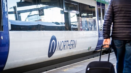 Image shows Northern train at platform with customer on the platform cropped-3