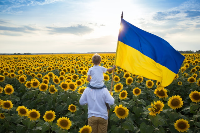 Father and son sunflowers flag