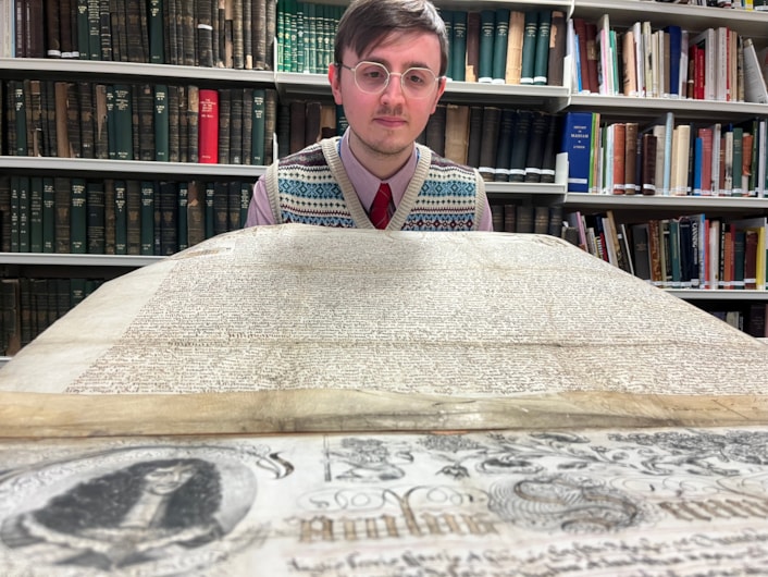 The Leeds Charter: Alex Pearson, archives assistant with West Yorkshire Archive Service with the copy of the Leeds Charter and  a second ornate charter, granted decades later in 1661 by Charles II.
The granting of the prestigious charter changed the course of the city’s history, laying the foundations of modern-day Leeds by incorporating it as a “free borough” and a “body corporate and politic.”