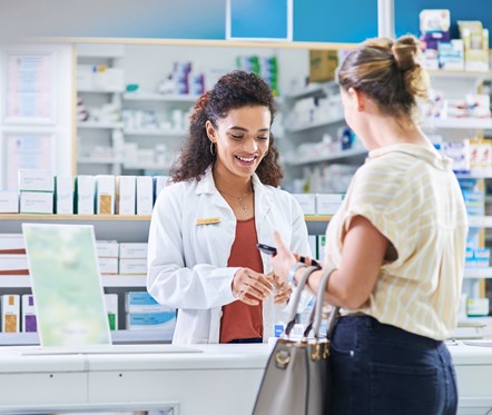 GettyImages-1262627528 (woman at counter pharmacy)