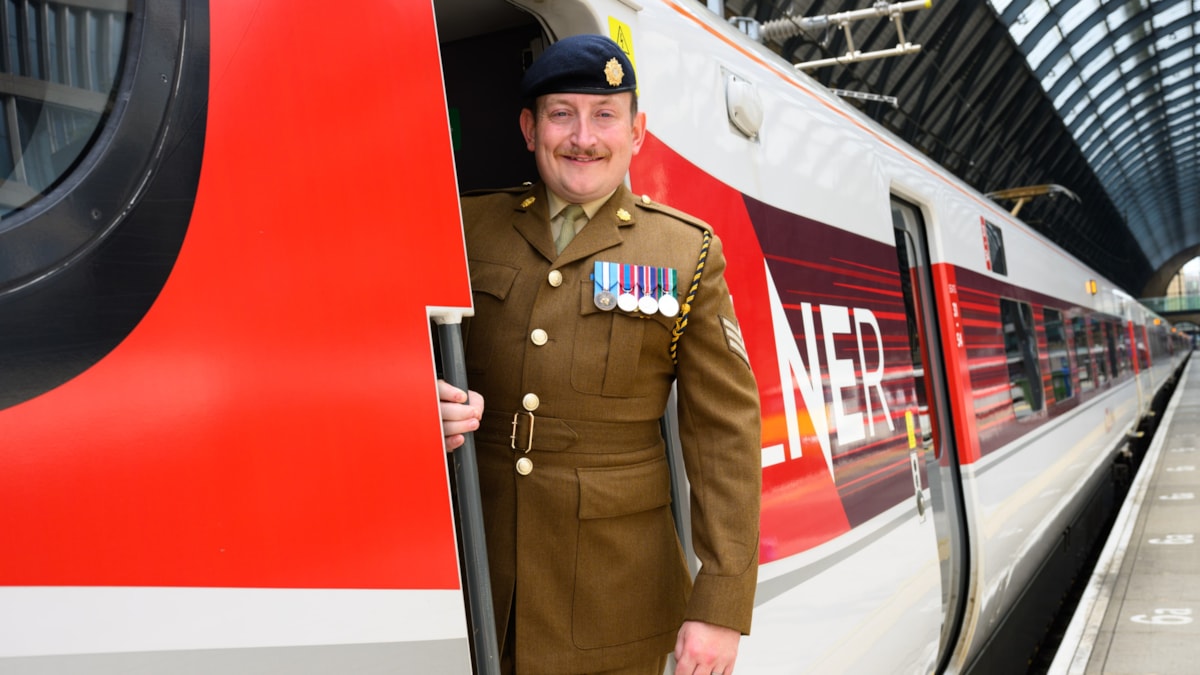 LNER driver Jamie Bond with an LNER Azuma at London King's Cross