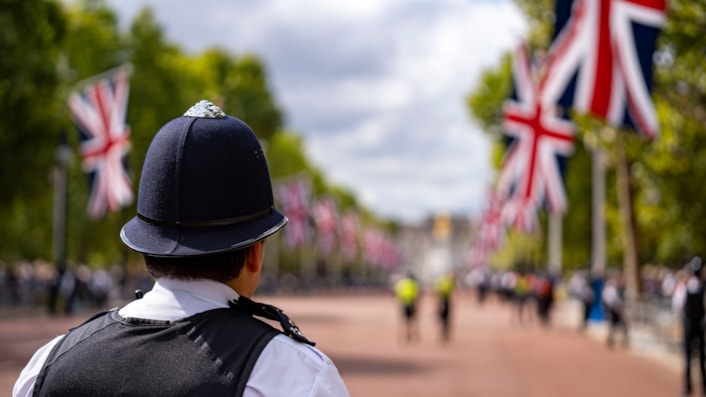 Officer pictured with union jack flags in background cropped: Officer pictured with union jack flags in background cropped