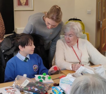 Hilary talks to one of the children and Miss Thompson