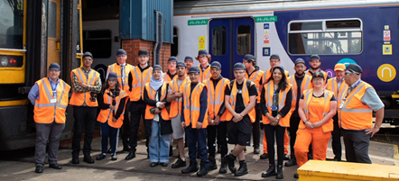 This image shows colleagues and students at Neville Hill depot in front of a Northern train