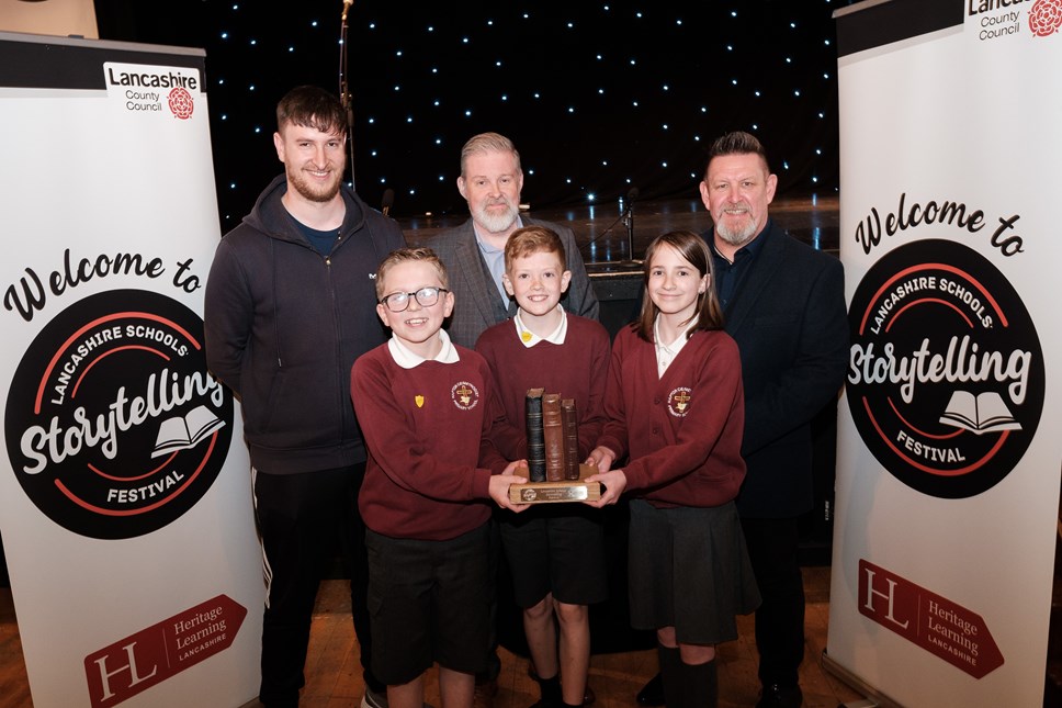 Methodist Primary School collect their trophy  (Back row, from left, teacher Ben Saville, David Brookhouse and John Merradith from Lancashire County Council)