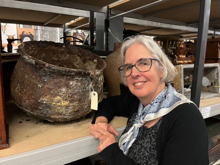 Cauldron: Curator Kitty Ross with the mysterious iron cauldron at the Leeds Discovery Centre.
The cauldron was originally discovered in a cellar in Chapeltown in 2012 after workers came to investigate a peculiar dripping sound which the resident could not locate.
Removing a wall, they discovered what appeared to be a petrified object which was later identified as a metal cauldron, sealed behind the wall in what is believed to have been part of an ancient practice designed to protect the house and its residents from malign or supernatural forces.