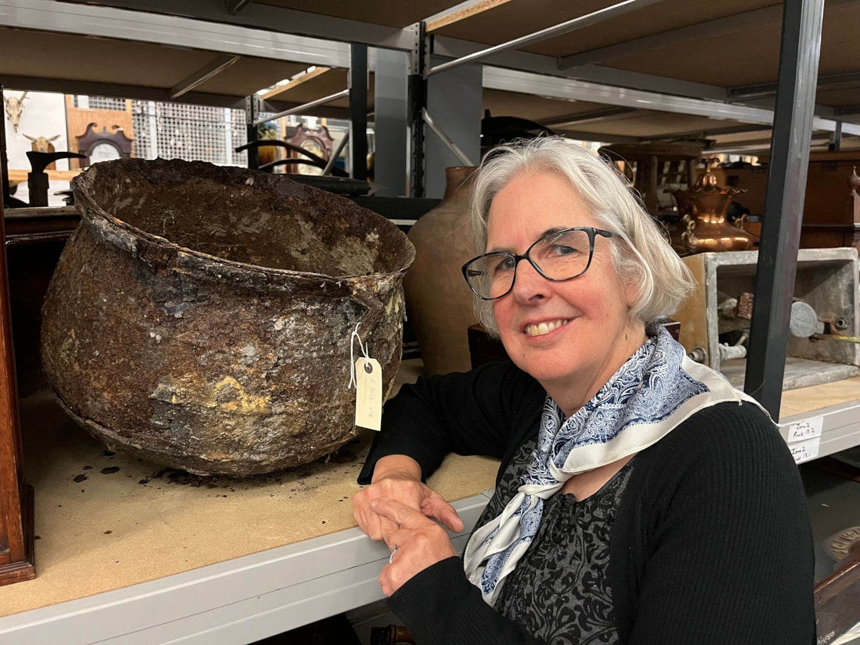 Cauldron: Curator Kitty Ross with the mysterious iron cauldron at the Leeds Discovery Centre.
The cauldron was originally discovered in a cellar in Chapeltown in 2012 after workers came to investigate a peculiar dripping sound which the resident could not locate.
Removing a wall, they discovered what appeared to be a petrified object which was later identified as a metal cauldron, sealed behind the wall in what is believed to have been part of an ancient practice designed to protect the house and its residents from malign or supernatural forces.