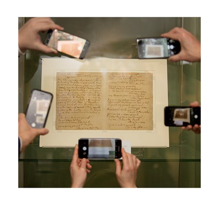 Visitors photograph Robert Burns' 'Holy Willie’s Prayer' (1785) and 'The Ordination: A Scotch Poem' (1786) at the National Library at Kelvin Hall on Burns Day last year.