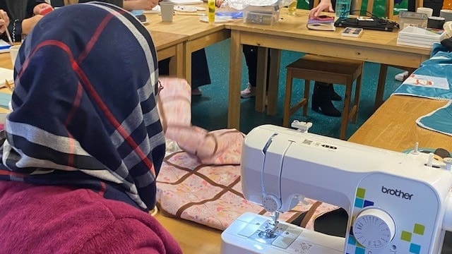 Afghan refugee Aziza sews an incubator cover for premature babies at a group run by Lancashire County Council’s Refugee Integration Team and local charity Roots to Branches.