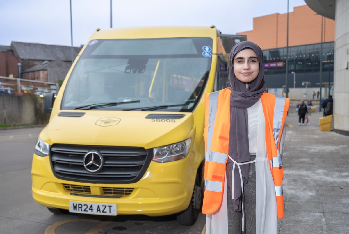 Amana T level student with Bee Network bus at Rochdale depot