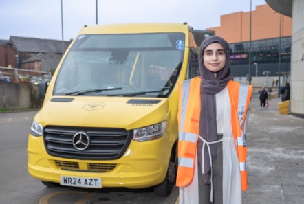 Amana T level student with Bee Network bus at Rochdale depot